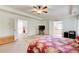 Open main bedroom featuring a large bed, recessed lighting, and doorways to a balcony and the bathroom at 1250 Edgebrook Ln, Snellville, GA 30078