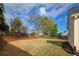 Spacious backyard featuring healthy grass, mature trees, and landscaping to create a private outdoor oasis at 2004 Westover Nw Ln, Kennesaw, GA 30152