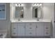 Bright bathroom featuring a double sink vanity, white cabinets, modern fixtures, and updated countertops at 2004 Westover Nw Ln, Kennesaw, GA 30152