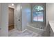 Soaking tub in bathroom with modern fixtures and a view of the outdoors at 2004 Westover Nw Ln, Kennesaw, GA 30152