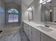 Elegant bathroom featuring double sinks, a soaking tub, and marble-look flooring at 2004 Westover Nw Ln, Kennesaw, GA 30152