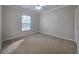 Neutral bedroom with a large window providing ample natural light and plush carpeting at 2004 Westover Nw Ln, Kennesaw, GA 30152