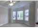 Cozy bedroom with large bay windows, ceiling fan, and neutral carpet at 2004 Westover Nw Ln, Kennesaw, GA 30152