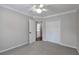 Bedroom featuring a closet and a doorway to another room, ceiling fan, and neutral carpet at 2004 Westover Nw Ln, Kennesaw, GA 30152