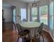 Dining area with hardwood floors, large windows with natural light, and modern light fixture at 2004 Westover Nw Ln, Kennesaw, GA 30152