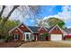 Charming one-story brick home featuring a well-manicured lawn, dormer windows, and attached two car garage at 2004 Westover Nw Ln, Kennesaw, GA 30152
