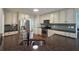 Updated kitchen features stainless steel appliances, granite countertops, tile backsplash, and hardwood floors at 2004 Westover Nw Ln, Kennesaw, GA 30152