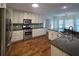 Open concept kitchen with granite countertops, stainless steel appliances, hardwood floors and eat-in breakfast nook at 2004 Westover Nw Ln, Kennesaw, GA 30152
