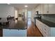 Spacious kitchen featuring stainless steel appliances, granite countertops, tile backsplash, and hardwood floors at 2004 Westover Nw Ln, Kennesaw, GA 30152