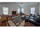 Spacious living room featuring a fireplace, vaulted ceilings, hardwood floors, lots of natural light and modern decor at 2004 Westover Nw Ln, Kennesaw, GA 30152
