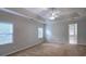 Spacious main bedroom featuring a tray ceiling, ceiling fan, and ample natural light at 2004 Westover Nw Ln, Kennesaw, GA 30152