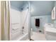 Compact bathroom featuring blue walls, shower-tub combo, and white fixtures at 2849 Livsey Woods Dr, Tucker, GA 30084