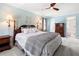 A primary bedroom with light blue walls, a wood bed frame, and a ceiling fan at 2849 Livsey Woods Dr, Tucker, GA 30084