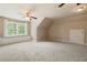 Spacious bonus room with a window seat, built-in storage and neutral carpet at 2849 Livsey Woods Dr, Tucker, GA 30084