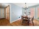 Cozy dining room featuring hardwood floors, natural light, and a stylish light fixture at 2849 Livsey Woods Dr, Tucker, GA 30084