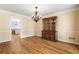 Dining room adjacent to the kitchen featuring hardwood floors and a dark wood China cabinet at 2849 Livsey Woods Dr, Tucker, GA 30084