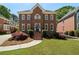 Beautiful brick home with manicured lawn, mature landscaping, and traditional architectural details at 2849 Livsey Woods Dr, Tucker, GA 30084