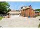 Exterior view showcasing a brick home with a large garage and expansive driveway at 2849 Livsey Woods Dr, Tucker, GA 30084