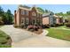 Elegant brick home with manicured landscaping, a driveway, and a welcoming entrance at 2849 Livsey Woods Dr, Tucker, GA 30084