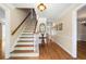 Inviting foyer featuring hardwood floors, staircase, traditional decor, and ample natural light at 2849 Livsey Woods Dr, Tucker, GA 30084