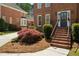 Brick home featuring traditional architectural details, manicured landscaping, and a welcoming front door at 2849 Livsey Woods Dr, Tucker, GA 30084