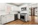 Bright kitchen featuring stainless steel appliances, white cabinets, and tile backsplash at 2849 Livsey Woods Dr, Tucker, GA 30084