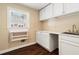 Functional laundry room featuring a sink, folding table, and cabinets for storage at 2849 Livsey Woods Dr, Tucker, GA 30084