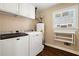 Clean laundry room featuring modern appliances, ample counter space, and natural light at 2849 Livsey Woods Dr, Tucker, GA 30084