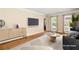 Bright living room featuring hardwood floors, a modern entertainment center, and stylish decor at 2849 Livsey Woods Dr, Tucker, GA 30084