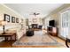 Comfortable living room featuring natural light, hardwood floors, fireplace and built-in shelving at 2849 Livsey Woods Dr, Tucker, GA 30084
