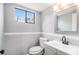 This bathroom has a gray vanity, a sink and a window at 3862 Northstrand Dr, Decatur, GA 30035