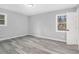 This bedroom has gray walls, wood-look flooring and two windows at 3862 Northstrand Dr, Decatur, GA 30035