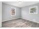 This bedroom has gray walls, wood-look flooring and two windows at 3862 Northstrand Dr, Decatur, GA 30035
