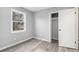 This bedroom has gray walls, wood-look flooring, a closet and a window at 3862 Northstrand Dr, Decatur, GA 30035