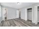 This bedroom has gray walls, wood-look flooring, a closet and bathroom at 3862 Northstrand Dr, Decatur, GA 30035