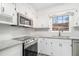This kitchen has white cabinets, stainless appliances and granite counters at 3862 Northstrand Dr, Decatur, GA 30035