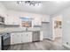 Bright kitchen features white cabinets, stainless steel appliances, and a window overlooking the backyard at 3862 Northstrand Dr, Decatur, GA 30035