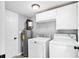 Utility room features a washer, dryer, water heater, and convenient overhead storage at 3862 Northstrand Dr, Decatur, GA 30035