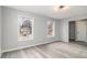 Light-filled living room featuring a large window and gray wood-look flooring at 3862 Northstrand Dr, Decatur, GA 30035
