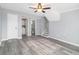 This living room has gray walls, wood-look flooring, a ceiling fan and stairs at 3862 Northstrand Dr, Decatur, GA 30035