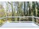 Looking out over the expansive backyard from a painted back deck with black metal railings at 1468 Cheyenne Ct, Stone Mountain, GA 30087