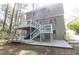 View of the home's tiered back decks, patios, and backyard from the lawn at 1468 Cheyenne Ct, Stone Mountain, GA 30087