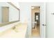 Bright bathroom with tile floor and vanity next to open door leading to upstairs landing with white railing at 1468 Cheyenne Ct, Stone Mountain, GA 30087