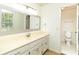 Bright bathroom featuring double sinks and a separate toilet room at 1468 Cheyenne Ct, Stone Mountain, GA 30087