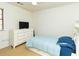 Bedroom with light blue comforter on bed, ceiling fan and dresser with TV at 1468 Cheyenne Ct, Stone Mountain, GA 30087