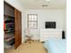 Bedroom with dresser, closet, chair, TV and a light blue comforter on the bed under a ceiling fan at 1468 Cheyenne Ct, Stone Mountain, GA 30087