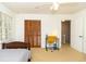 Bedroom featuring carpet, a ceiling fan, closet, a twin bed, and a desk by the window at 1468 Cheyenne Ct, Stone Mountain, GA 30087