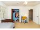 Cozy bedroom features a ceiling fan, closet, and a desk by the window at 1468 Cheyenne Ct, Stone Mountain, GA 30087