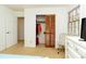 Bedroom featuring an open closet, adjacent to a door and dresser, and a TV across from a light blue comforter bed at 1468 Cheyenne Ct, Stone Mountain, GA 30087