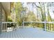Exterior view of deck with black iron railings and a wooden floor overlooking the lush green yard at 1468 Cheyenne Ct, Stone Mountain, GA 30087